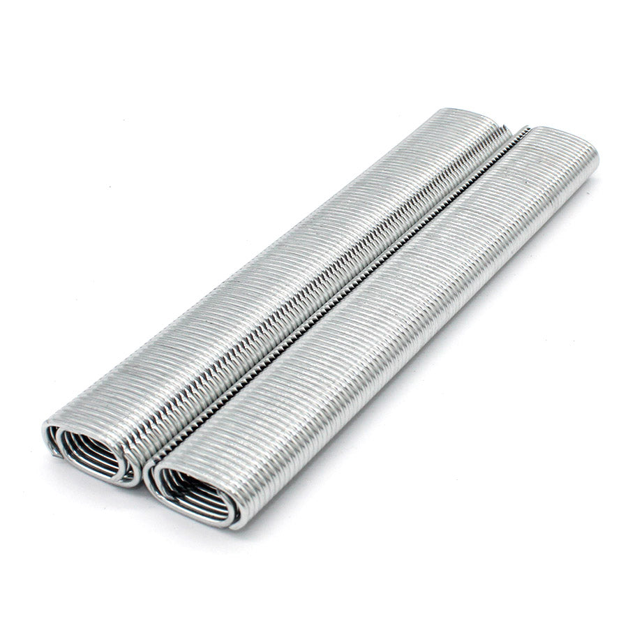 Silver metal hog rings, two coiled rolls side by side