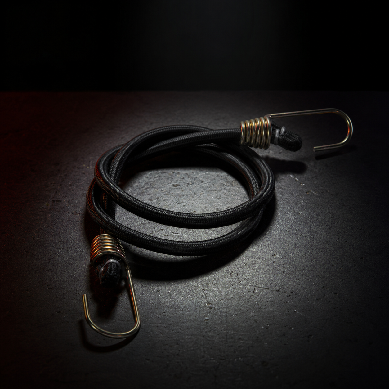 Black bungee cord assembly with gold metal hooks and coil spring sleeves