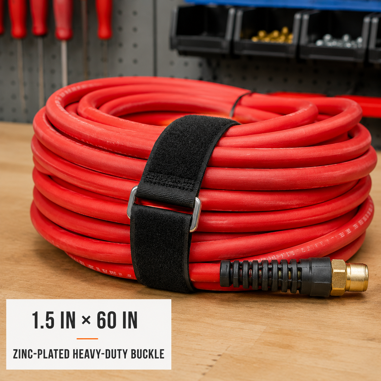 1.5 inch by 60 inch black cinch strap with zinc-plated heavy-duty buckle organizing a large air hose