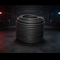 Dark rubber elastic cord spool, tightly coiled on a round reel