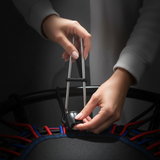 Trampoline bungee cords with installation tool, hands tightening black cord loop