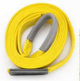 Coiled yellow tow strap with gray loop ends and end hardware