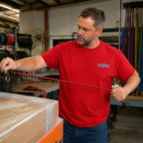 Red crewneck T-shirt worn by man with small chest logo
