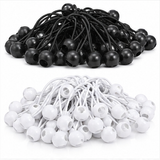 Black and white ball bungee tie-down cord sets with molded ball tips, laid out