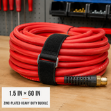 1.5 inch by 60 inch black cinch strap with zinc-plated heavy-duty buckle organizing a large air hose