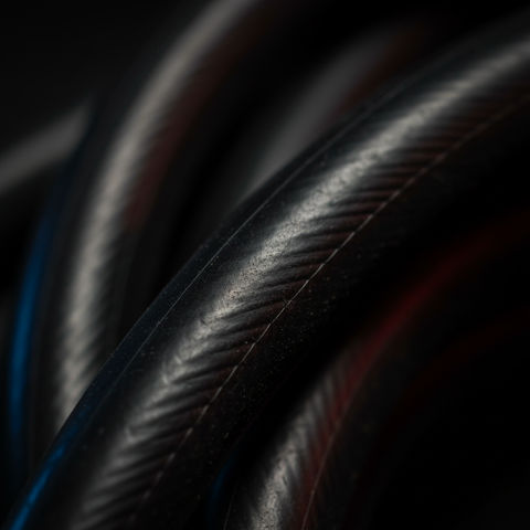 Close-up of dark rubber elastic cord with smooth, ridged surface