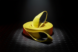 Yellow recovery tow strap with black loops resting on textured metal plate
